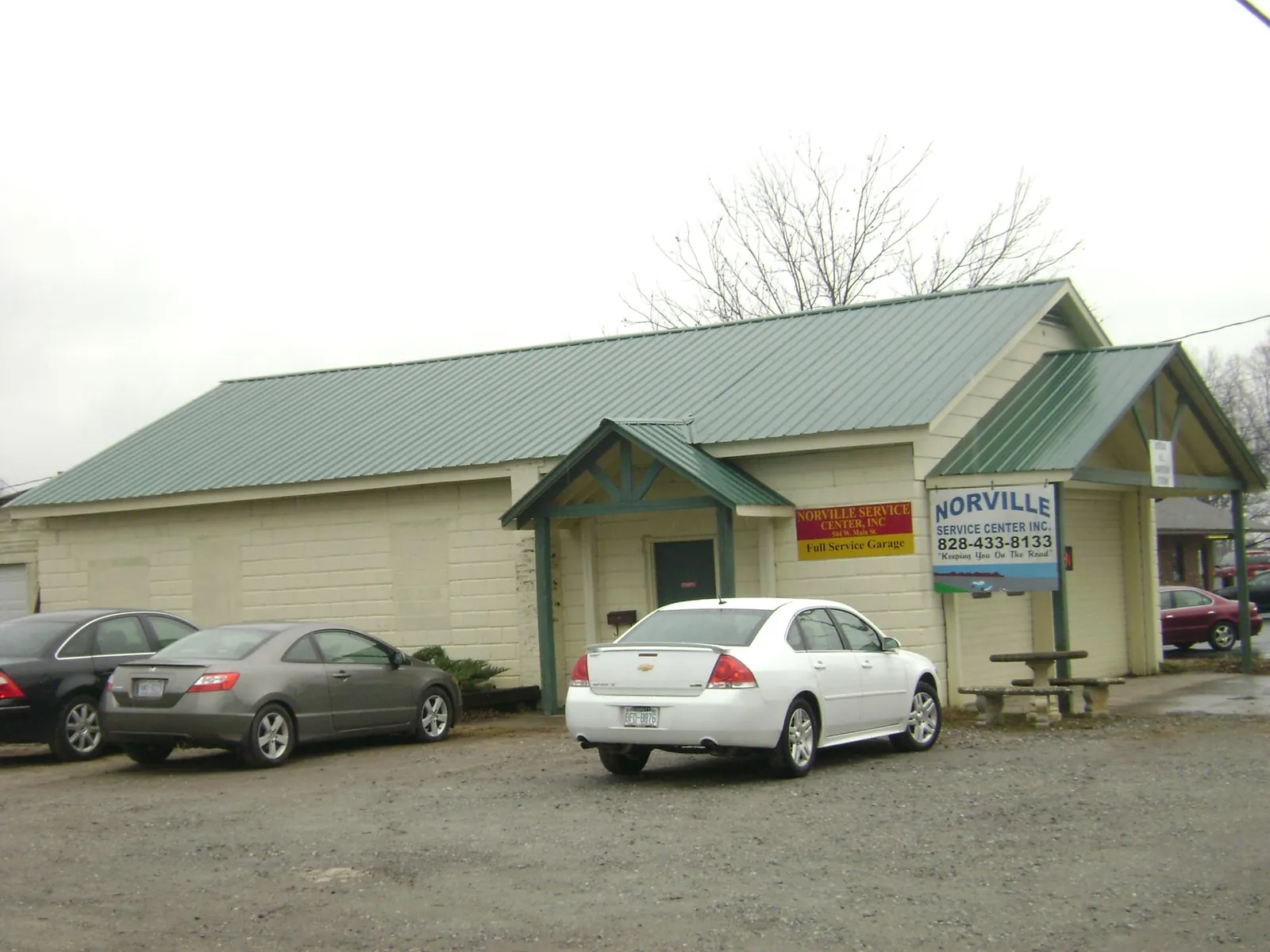 Green metal roof on a service garage with a covered entry in North Lima