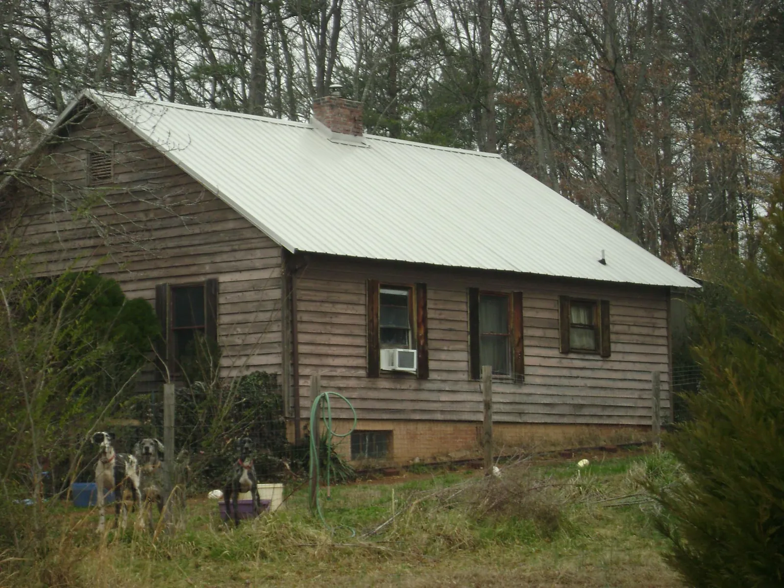 White metal roof on an old wood sided farmhouse, from a Metal Roof Installation job in North Lima